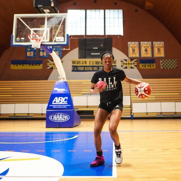 Young female basketball player training