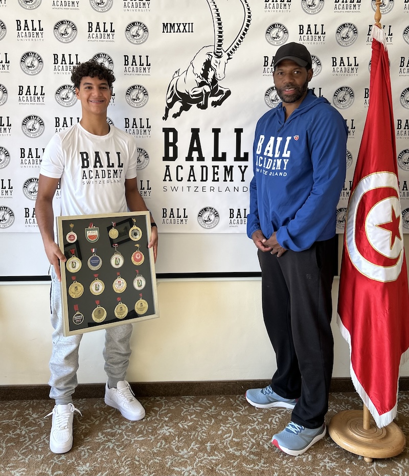 Adem Rafrafi showing his medals at signing with Antoine Gillespie, Ball Academy in Tunisia